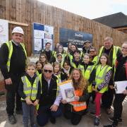 Children at the retirement home site in Studley with the time capsule about to be buried. Left: Andy Feeney. Front row from left (kneeling): Glyn Slade, Jennifer Rigby. Second from right: Cllr Phil Hunt (Studley Parish Council). Right: Matilda Rigby
