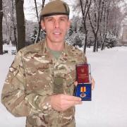CSgt Stuart Collins with his medal for his work in Ukraine. Photo: Mercian Regiment.