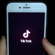 TikTok app open on a phone. Credit: PA