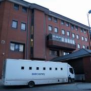 A custody van enters Birmingham Crown Court ahead of the trial of three men who are accused of the murder of 23-year-old footballer Cody Fisher.