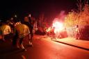 Police attempt to put out flares that have been thrown towards them outside the stadium before the UEFA Europa Conference League Group E match at Villa Park, Birmingham