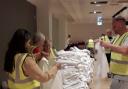 Volnuteers sorting Uniform Bank donations