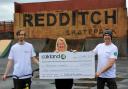 Redditch Wheels Project receiving their big cheque, Kieron Cull and project director Steve Rooke with Oakland Foundation grant application coordinator Debbie Roberts..