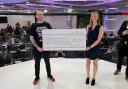 Jess and James Whiston holding the cheque at Fight Night