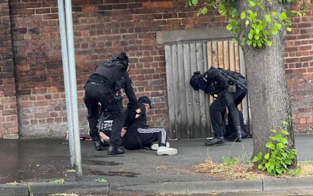 Redditch Advertiser: Armed police apprehend a man thought to be in possession of a gun