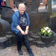 Ros Sidaway, festival director, at the John Bonham Memorial with flowers laid to commemorate the 41st anniversary of his death.