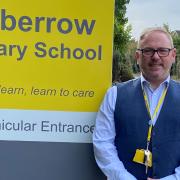 Headteacher, Glenn Duggan-Seville, with the new signage at Inkberrow Primary School